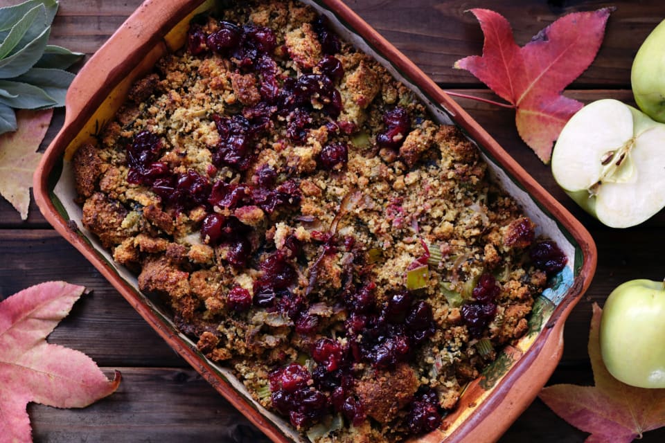 Stuffing has been eaten since at least the time of the Romans, and probably before. Image of a baking dish filled with stuffing, mixed with bread crumbs and dried fruit.