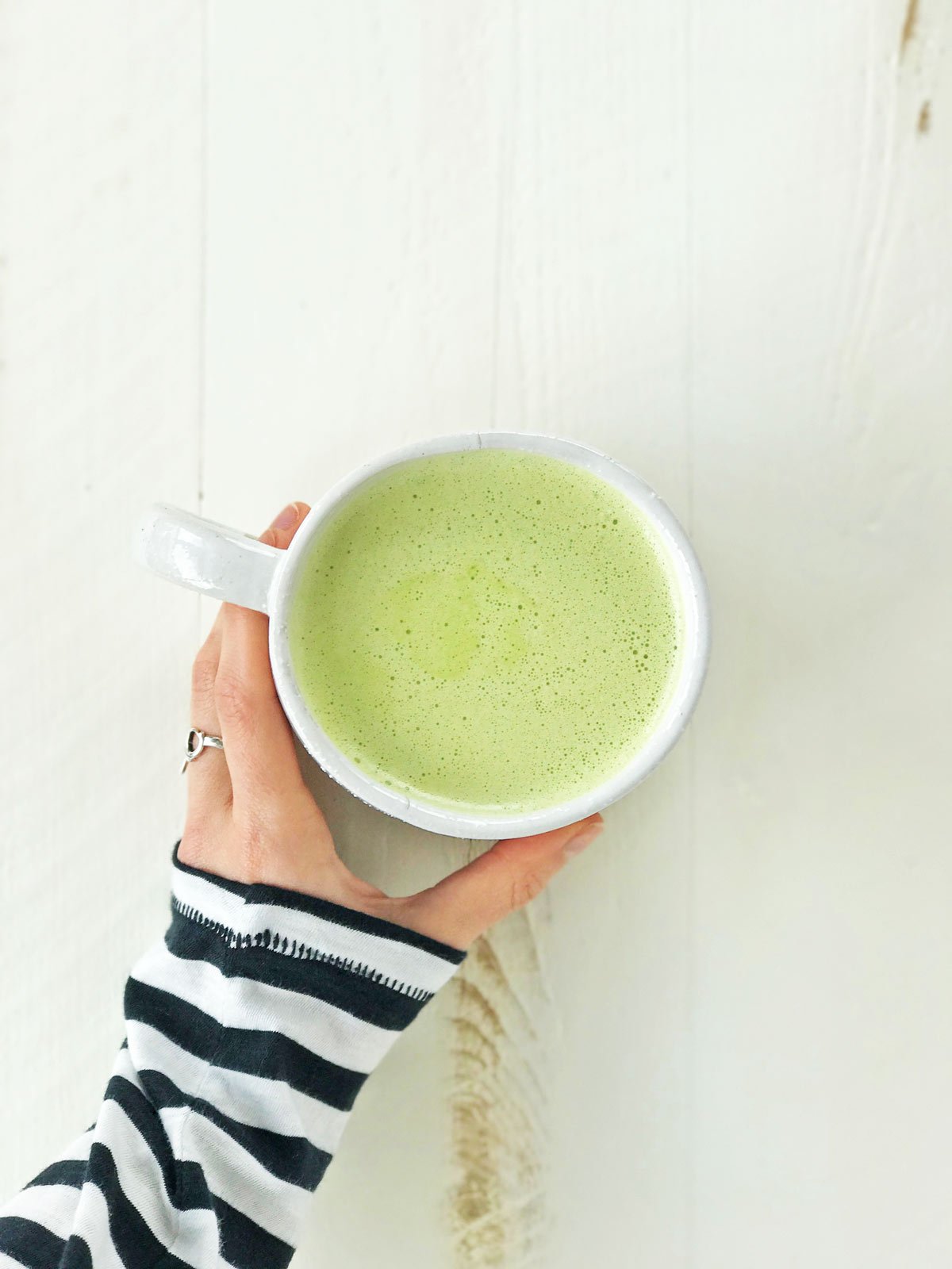 hand holding a matcha latte