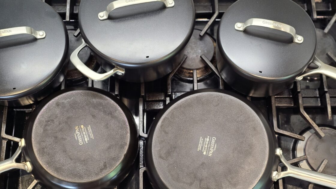 image of a set of clean cookware tested by chef Laura Klein, the collection laid out on her gas stovetop view from above.