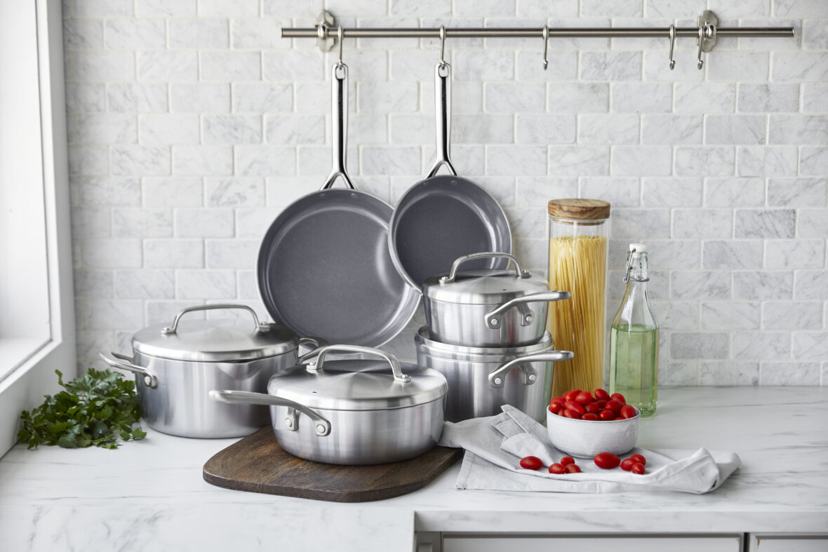 iamge of a set of non-toxic nonstick pans with a stainless steel exterior on a modern countertop.