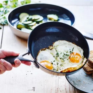 Image of cooking up eggs and sliding onto a plate. GreenPan's Venice Pro Noir safe ceramic cookware non toxic. Their thermolon is one of the safest cookware materials to cook with. Their non stick pans are excellent to cook with and don't leach toxic chemical into food. We've reviewed the best ceramic cookware sets tested.