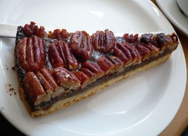 Image of a slice of pumpkin pie on a white plate.