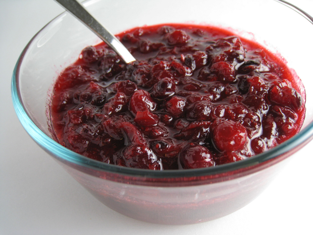 Image of cranberry sauce to accompany Thanksgiving dishes in a glass bowl.