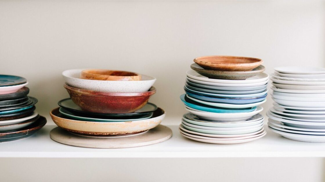 Image of stacks of melamine plates and bowls on white shelf against and white wall. The FDA says melamine is safe---except when it's not.