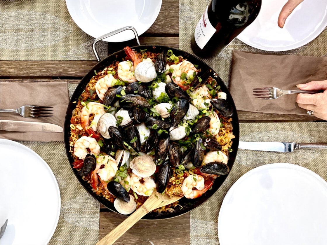 Paella in paella pan on table