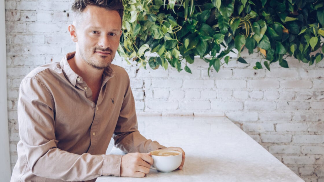 Dr. Will Cole with a coffee cup