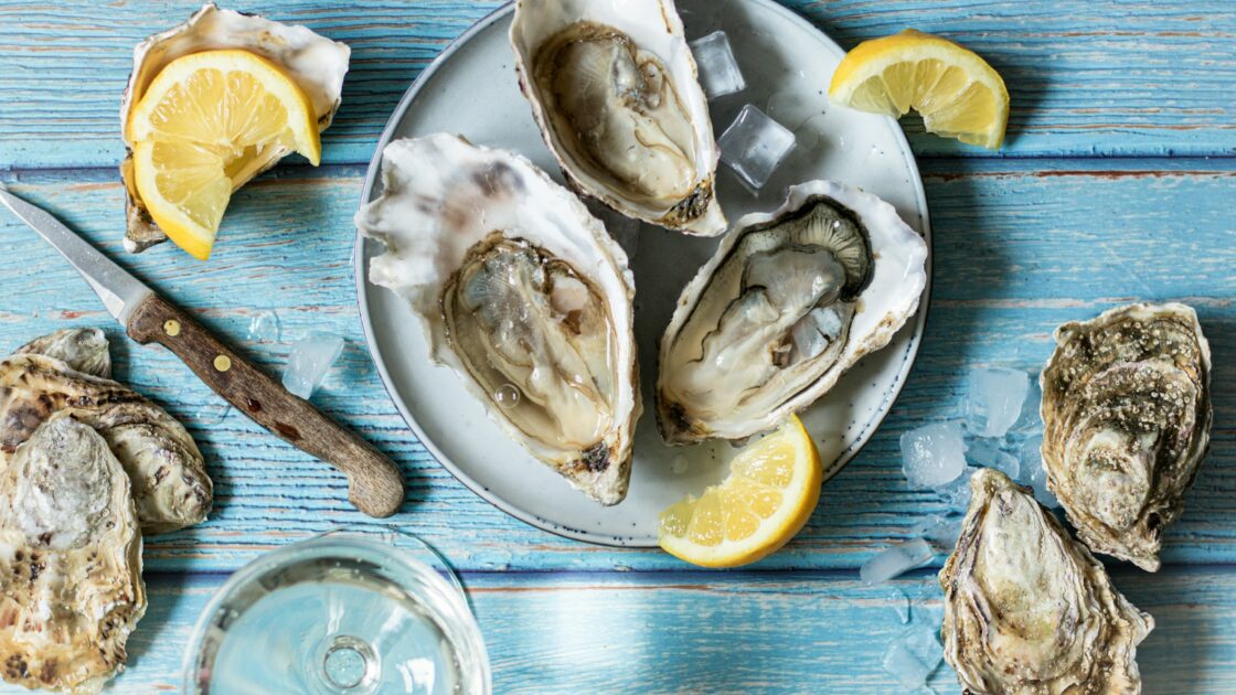 image of oysters on the half shell on a plate with lemon representing aphrodisiac foods.