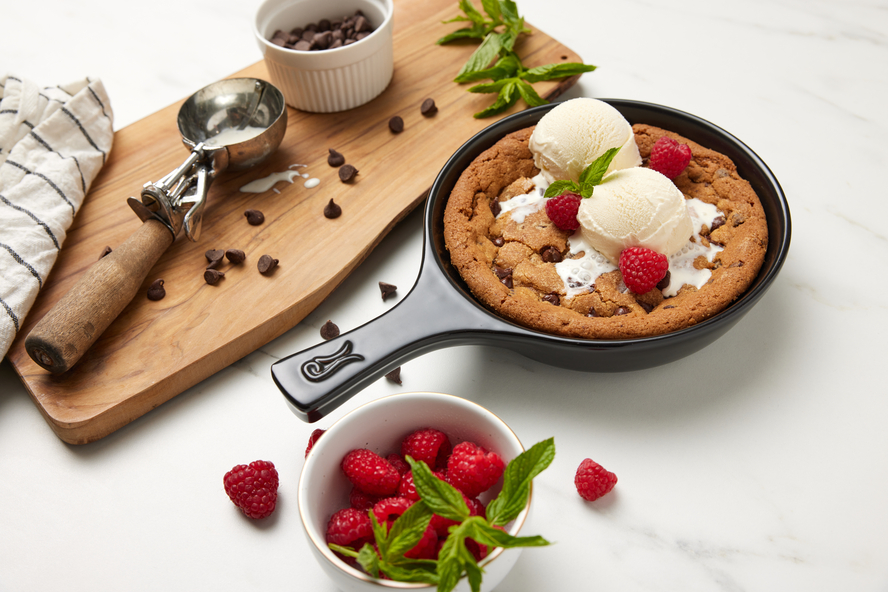 Image of the Xtrema Cookware 7-inch Signature Skillet filled with a chocolate chip cookie and vanilla ice cream.