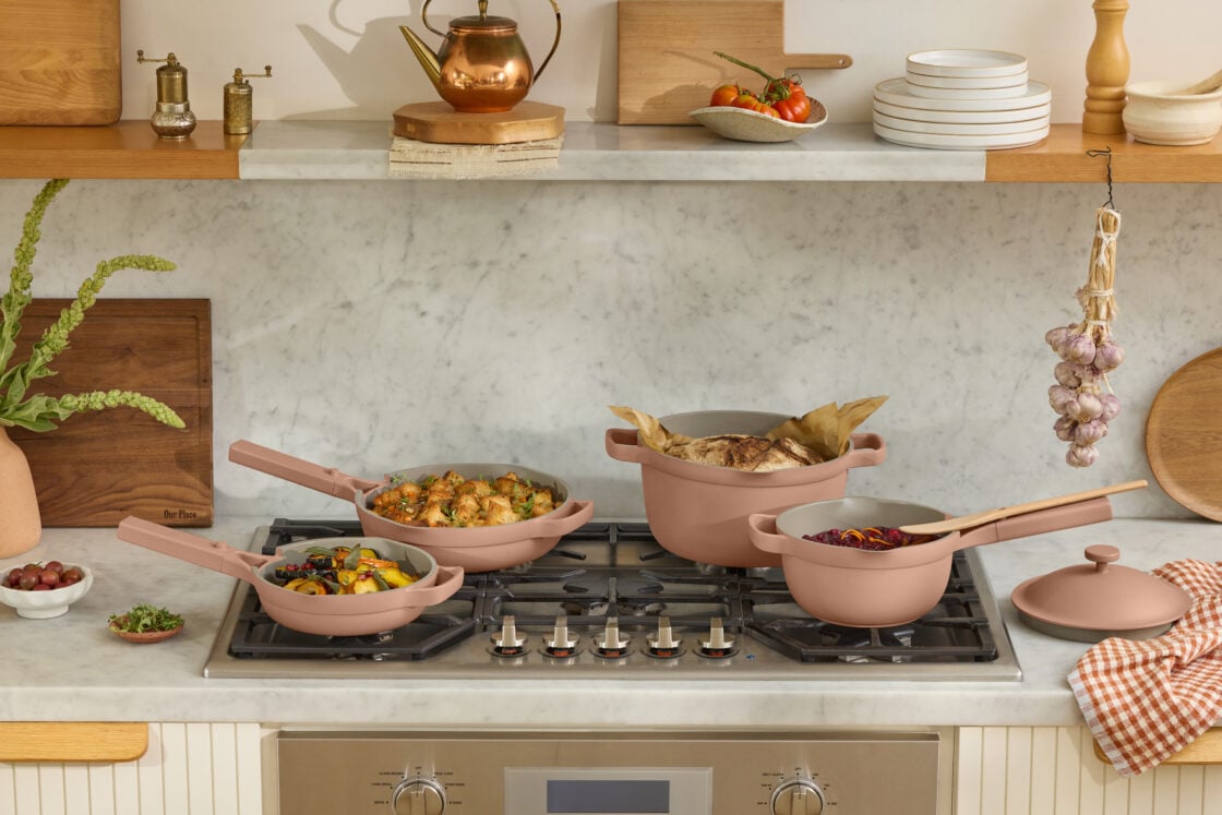 Image of Our Place 4-piece set of nontoxic, sustainably made cookware in a pretty, dusty rose on a modern gas range in a gorgeous kitchen.